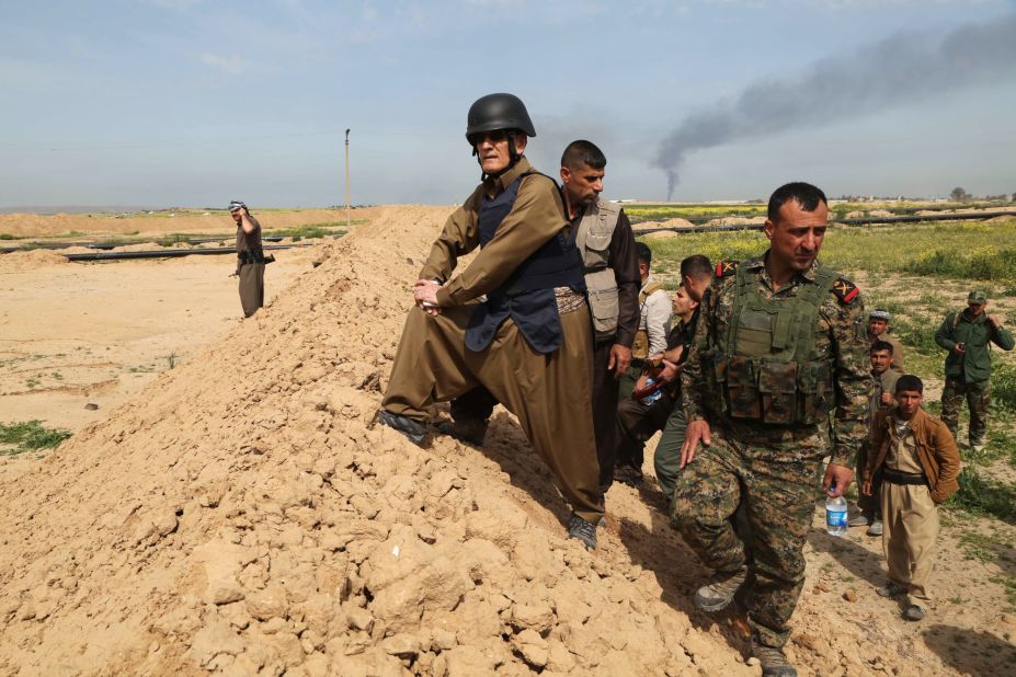 The Iraqi governor of Kirkuk, Najmiddin Karim stands on a trench alongside Iraqi Kurdish Peshmerga fighters in the city of Kirkuk in March 2015, after the Peshmerga fighters reportedly re-took parts of the area from ISIS.