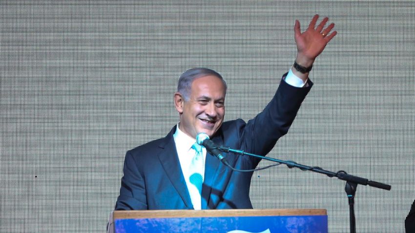 Israeli Prime Minister Benjamin Netanyahu greets supporters at the party's election headquarters In Tel Aviv.Tuesday, March 17, 2015. Exit polls from Israel's national elections showed Prime Minister Benjamin Netanyahu's Likud party nearly deadlocked with Isaac Herzog's center-left Zionist Union. (AP Photo/Oded Balilty)