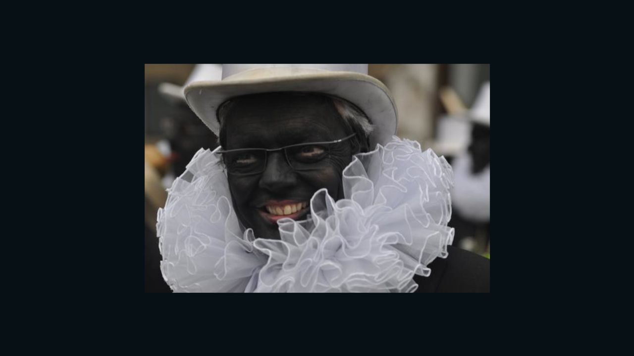 Belgian Foreign Minister Didier Reynders gives a TV interview while wearing blackface.