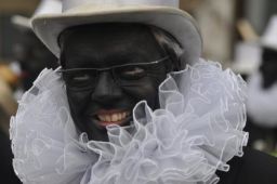 Belgian Foreign Minister Didier Reynders gives a TV interview while wearing blackface.