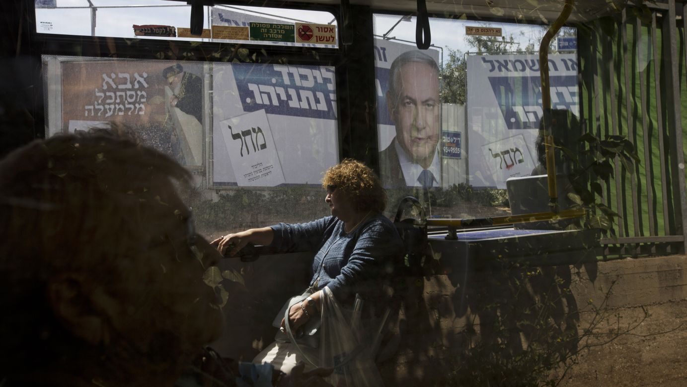 Passengers sit on a bus in Bnei Brak, Israel, as it passes a billboard of Israeli Prime Minister Benjamin Netanyahu on Monday, March 16. <a href="http://www.cnn.com/2015/03/17/world/gallery/israel-elections/index.html" target="_blank">Netanyahu appears poised to keep his job</a> after his Likud party grabbed at least 29 of the 120 seats in Israel's parliament, according to unofficial numbers from the Israeli election committee.
