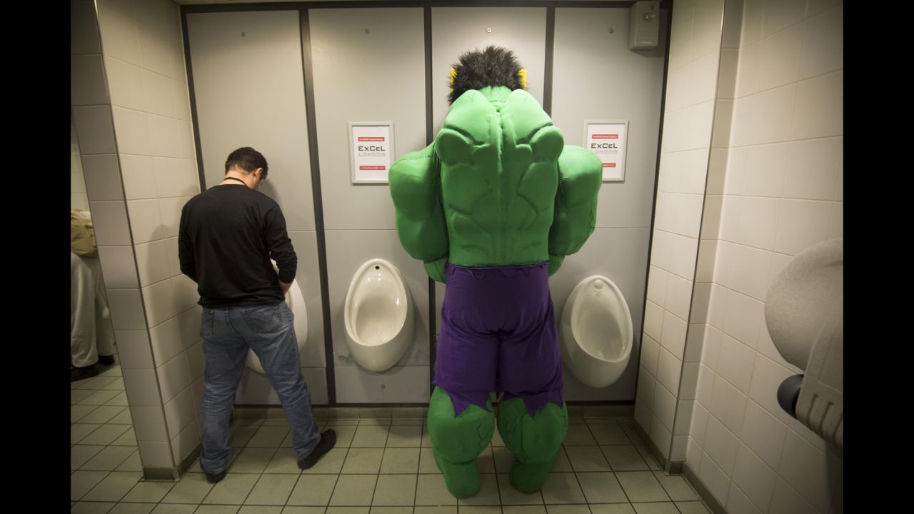 A man dressed up as the Incredible Hulk uses the restroom Saturday, March 14, during the London Super Comic Convention.