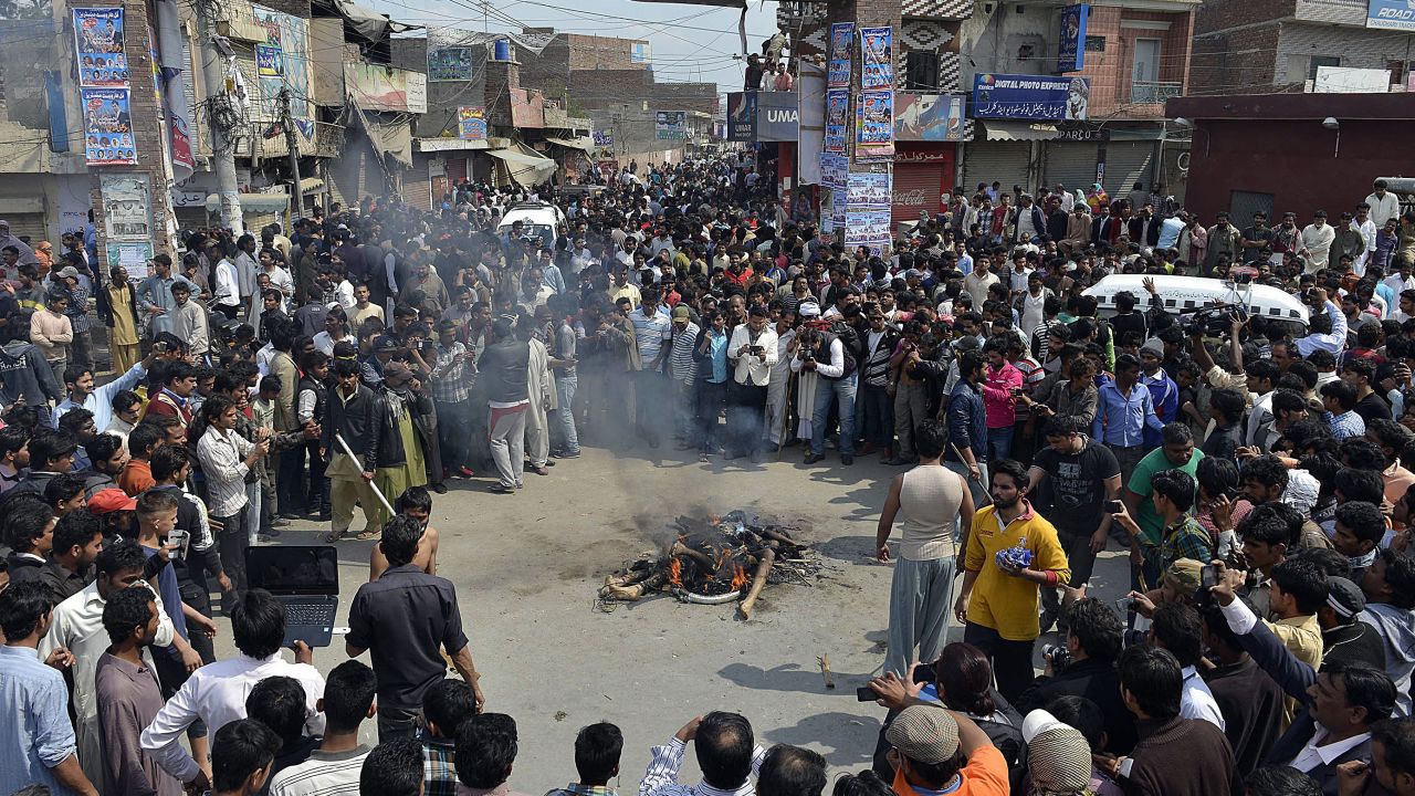 An angry mob in Lahore, Pakistan, gathers around the burning bodies of two suspected associates of Taliban attackers following <a href="http://www.cnn.com/2015/03/15/world/gallery/pakistan-bombing/index.html" target="_blank">suicide bombings that targeted Christian churches</a> on Sunday, March 15.