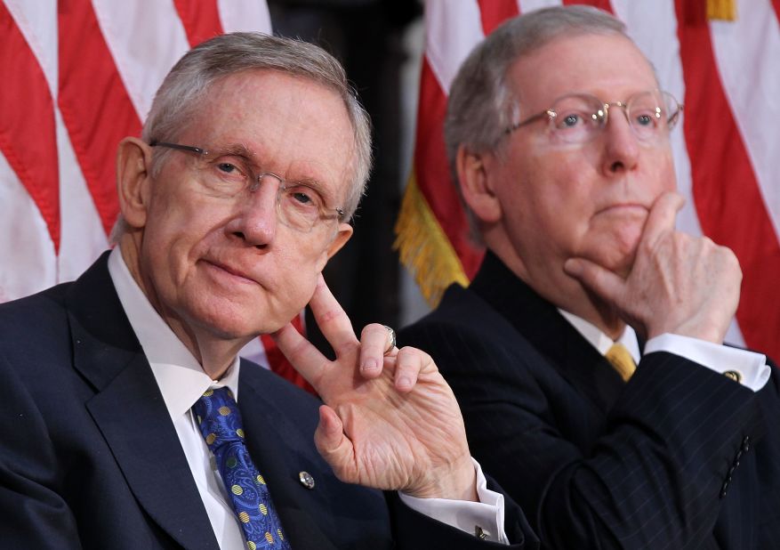 Senate Majority Leader Harry Reid, D-Nevada, and McConnell listen during a dedication ceremony of the statue of former President Gerald Ford at the Rotunda of the U.S. Capitol in May 2011.
