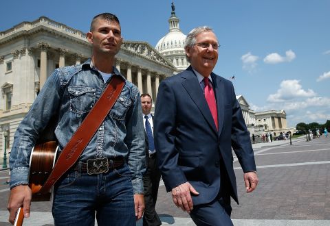 McConnell walks with "America's Got Talent" contestant Jimmy Rose to a news conference on the economic ramifications of the Environmental Protection Agency's proposed power plant rules in July 2014.