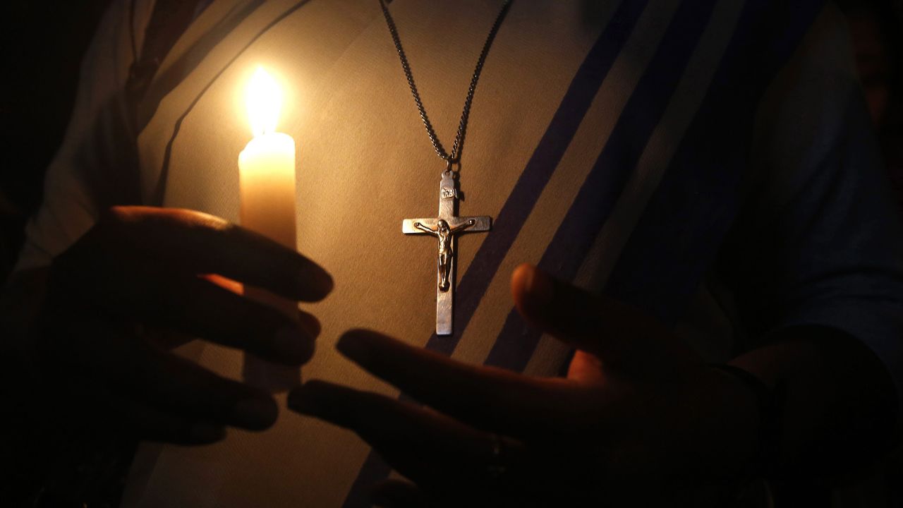 A nun holds a candle Monday, March 16, as she prays during a vigil to condemn <a href="http://www.cnn.com/2015/03/14/asia/nun-raped-in-india/index.html" target="_blank">the rape of a 71-year-old nun</a> in Ranaghat, India. A senior official said the rape occurred when a gang of robbers struck a Christian school on Saturday, March 14.