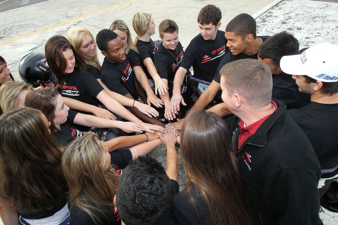 Drivers form a team huddle before going out on their track activities during the 2012 NASCAR Drive For Diversity Combine at Langley Speedway, Virginia.