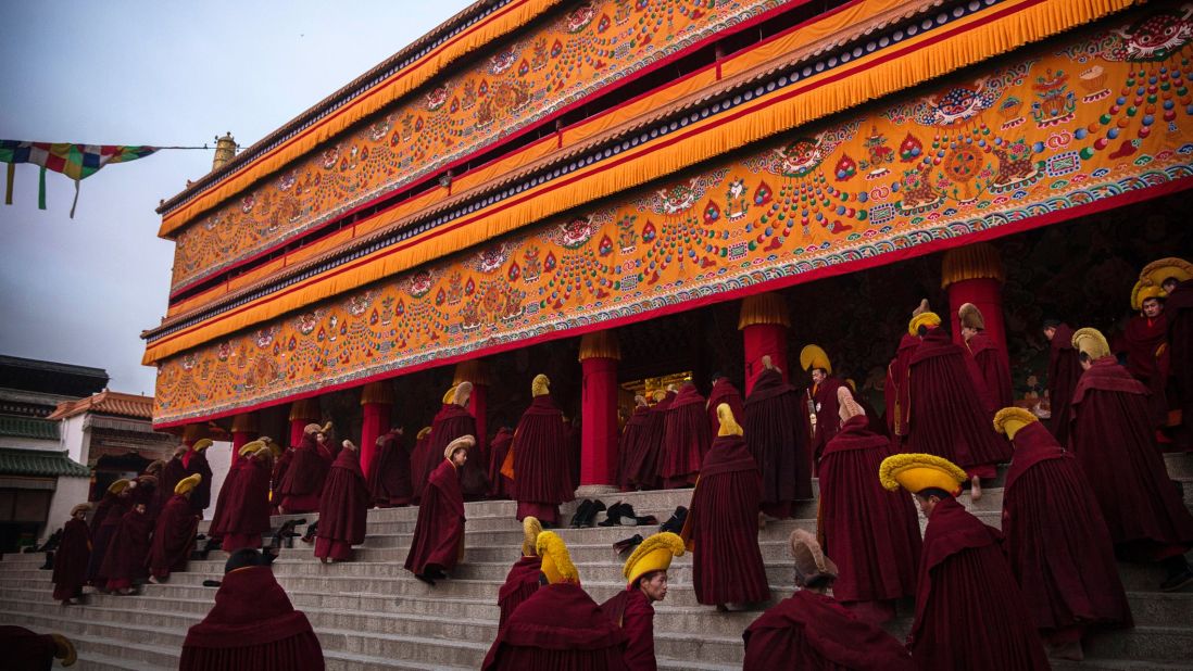 Monks of the Gelug, Tibetan Buddhism's "Yellow Hat" order, arrive for morning prayers on March 3, 2015. 