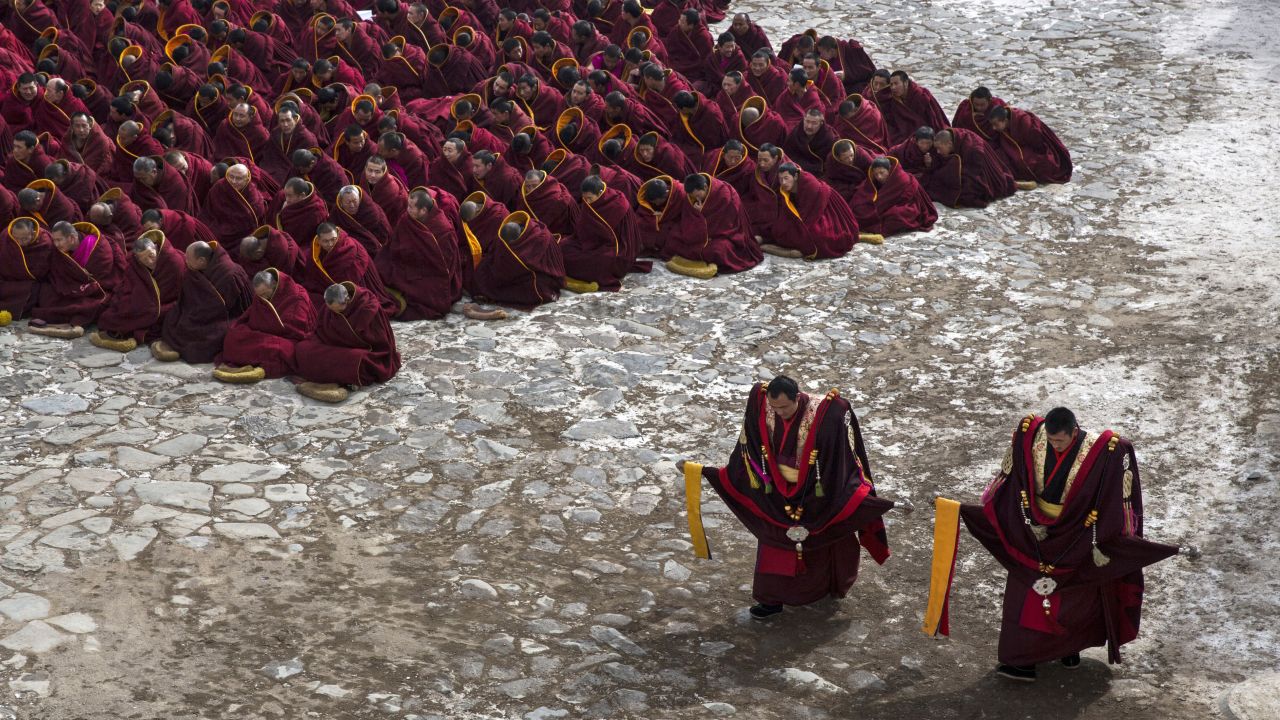 Tibetan Buddhist monks at Labrang Monastery sit on the ground during a special prayer on March 5, 2015.