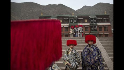 Tibetan Buddhists wear traditional clothing as they wait to take part in a procession at Labrang Monastery on March 4, 2015.