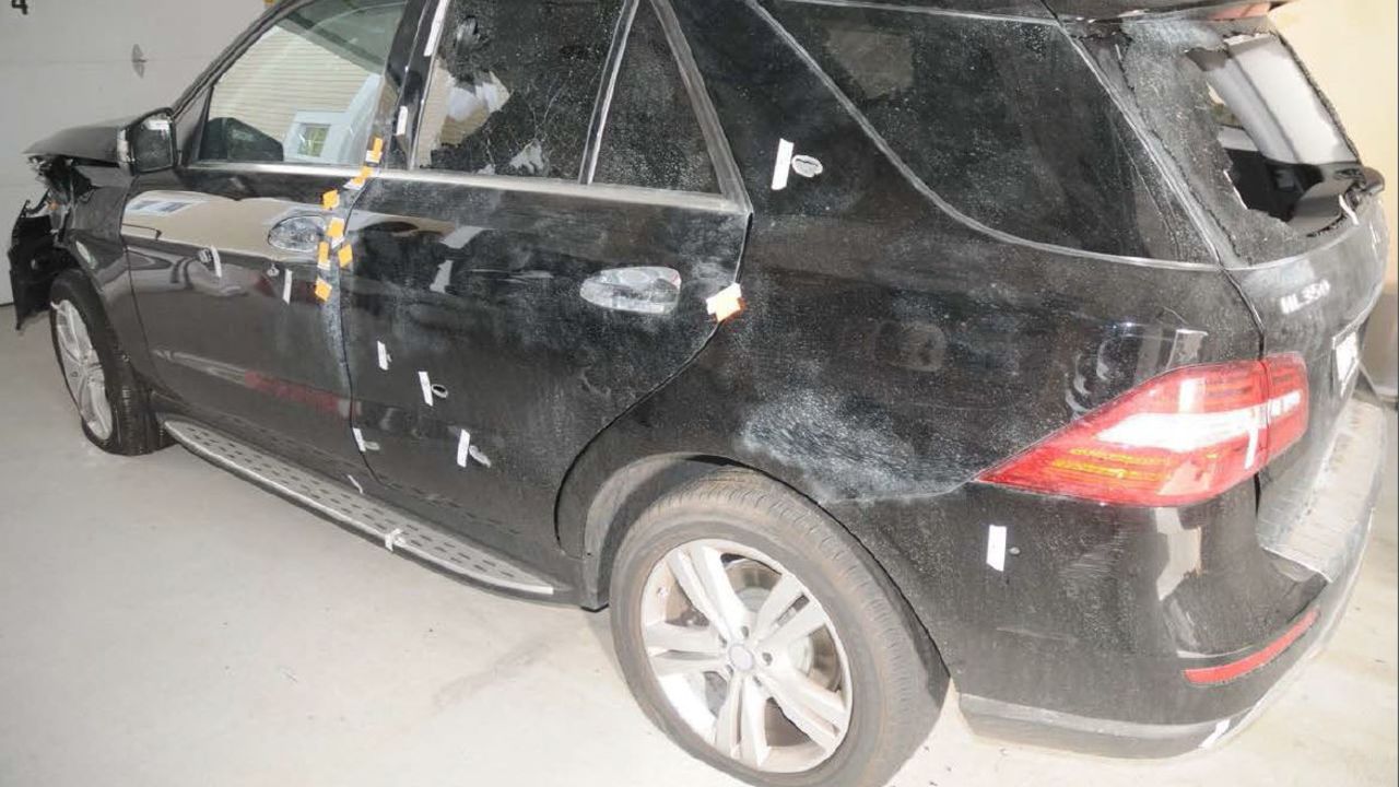 The carjacked Mercedes SUV was covered in bulletholes, and the rear window was shattered.