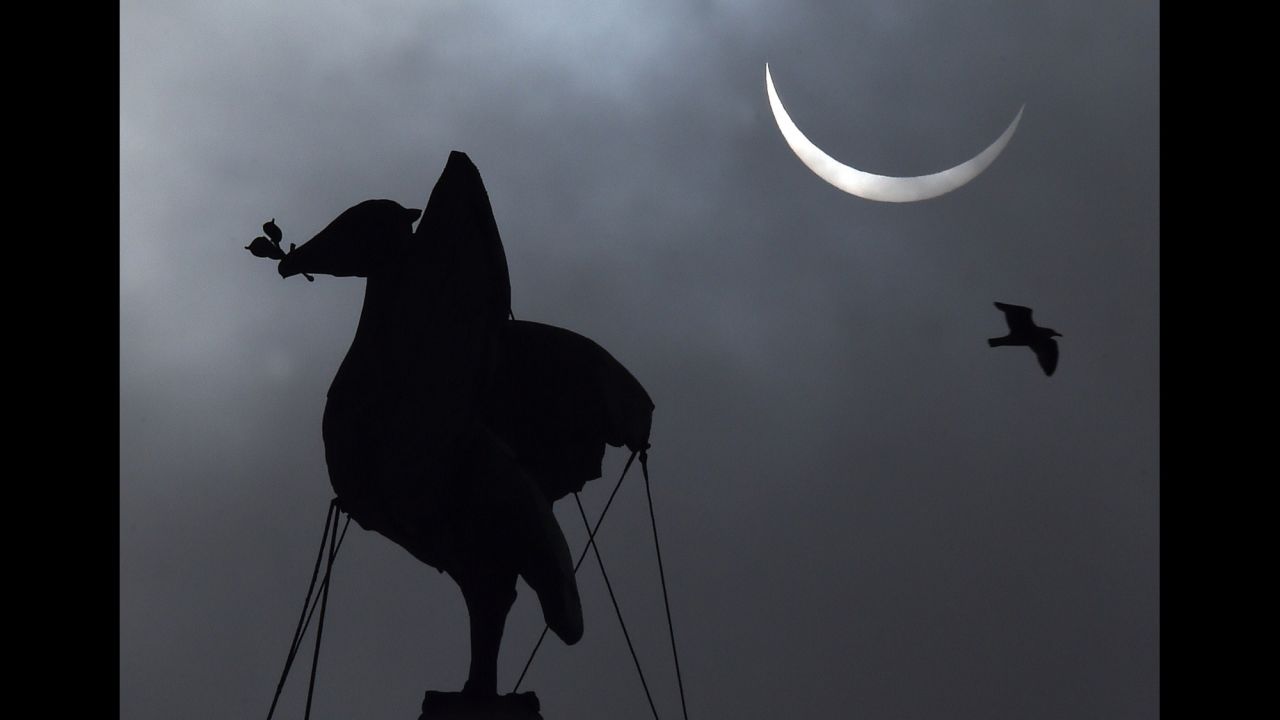 The eclipse forms above the Liver Bird on top of the Liver Building in Liverpool, England.