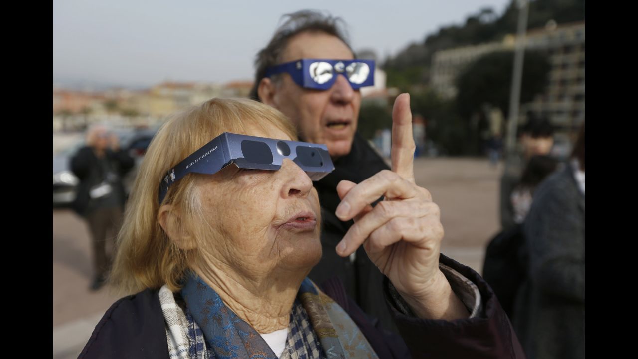 People in Nice, France, use protective glasses to watch the eclipse.