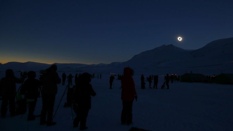 People view the total solar eclipse in Svalbard, Norway.