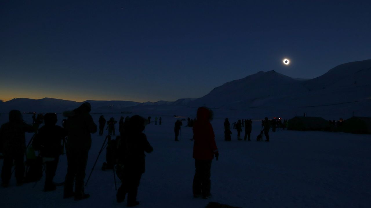 People view the total solar eclipse in Svalbard, Norway.