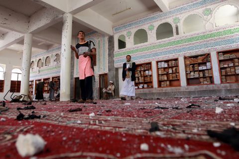 Armed men inspect damage after an explosion at Al Badr mosque in Sanaa, Yemen, on Friday, March 20. Deadly explosions in Yemen's capital rocked two mosques serving a minority Muslim group that recently conquered the city. The mosques serve members of the Zaidi sect of Shiite Islam, which is followed by the Houthi rebels who recently took control of the capital.