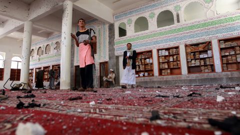 Armed men inspecting the damage following a bombing at the Badr mosque in Sanaa on March 20, 2015.