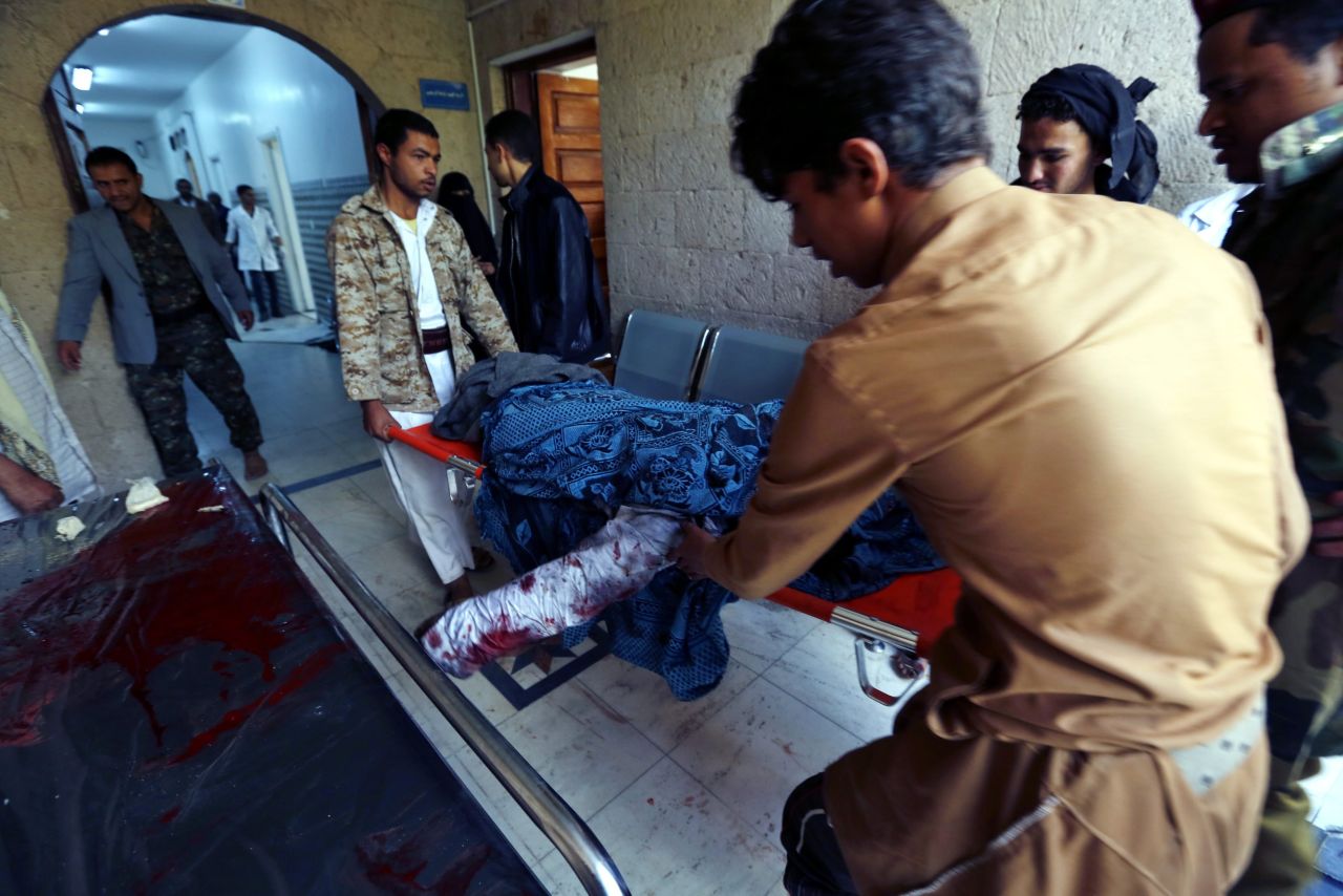 The body of a person killed in the attacks is carried to a hospital in Sanaa on March 20.