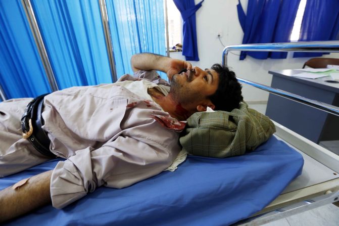 A wounded man lies on a bed at a hospital after the bombings in Sanaa on March 20.