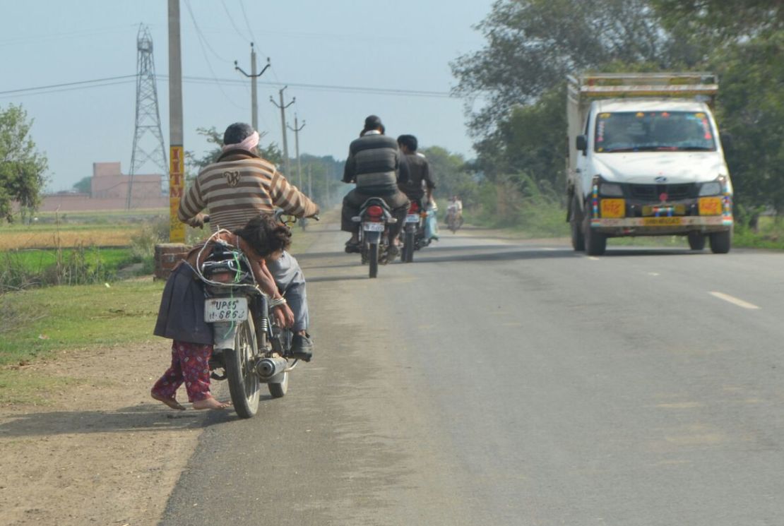 One father, desperate to get his daughter to sit her exams, lashed her to his motorbike to make sure she got to school.