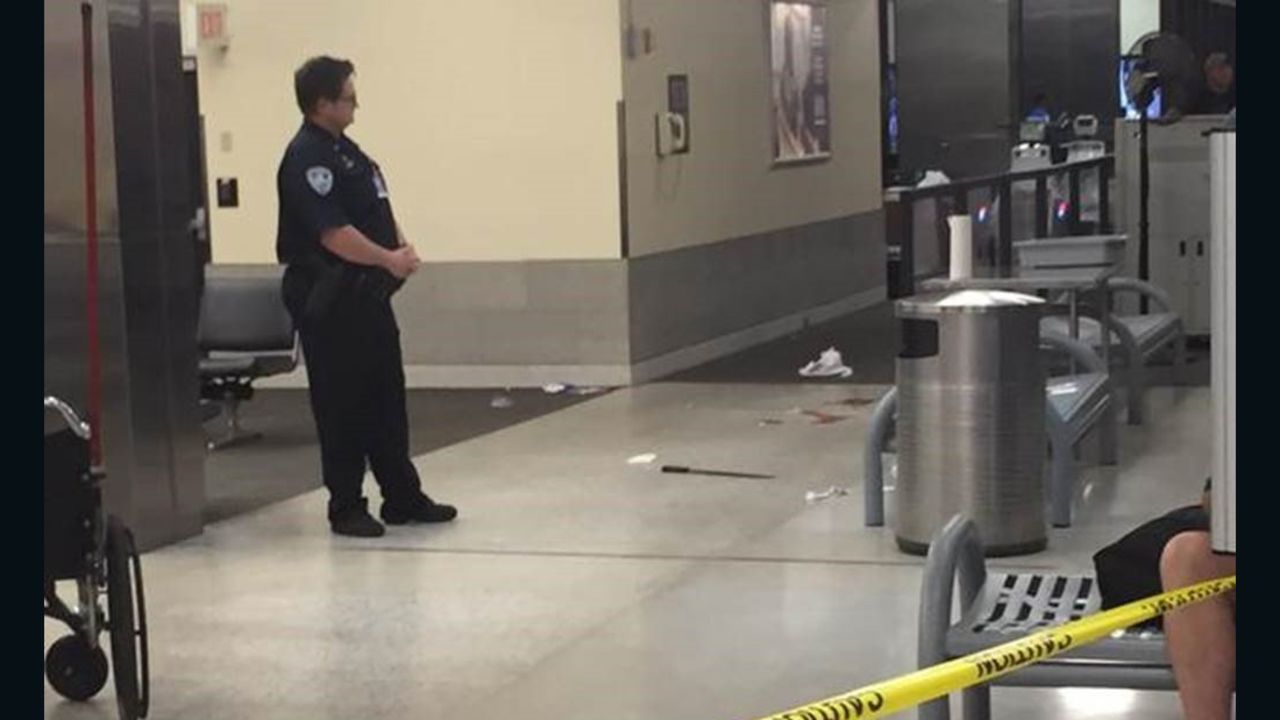 The machete allegedly used against TSA officers is seen on the floor of the airport.