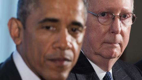 President Barack Obama sits beside McConnell before a meeting in the Cabinet Room at the White House on January 13.