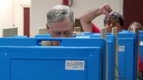 A voter gives a thumbs-down as McConnell votes in the midterm elections in November 2014 in Louisville, Kentucky.