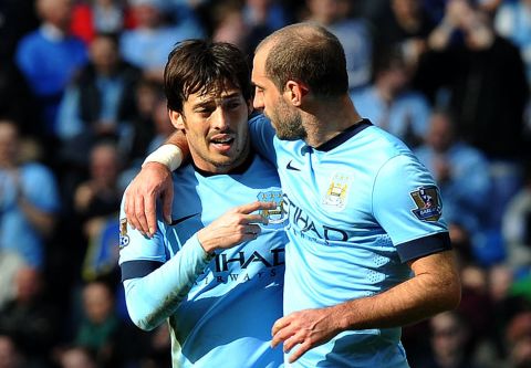 David Silva (left) celebrates with teammate Pablo Zabaleta after making it 3-0 to City late in the second half.