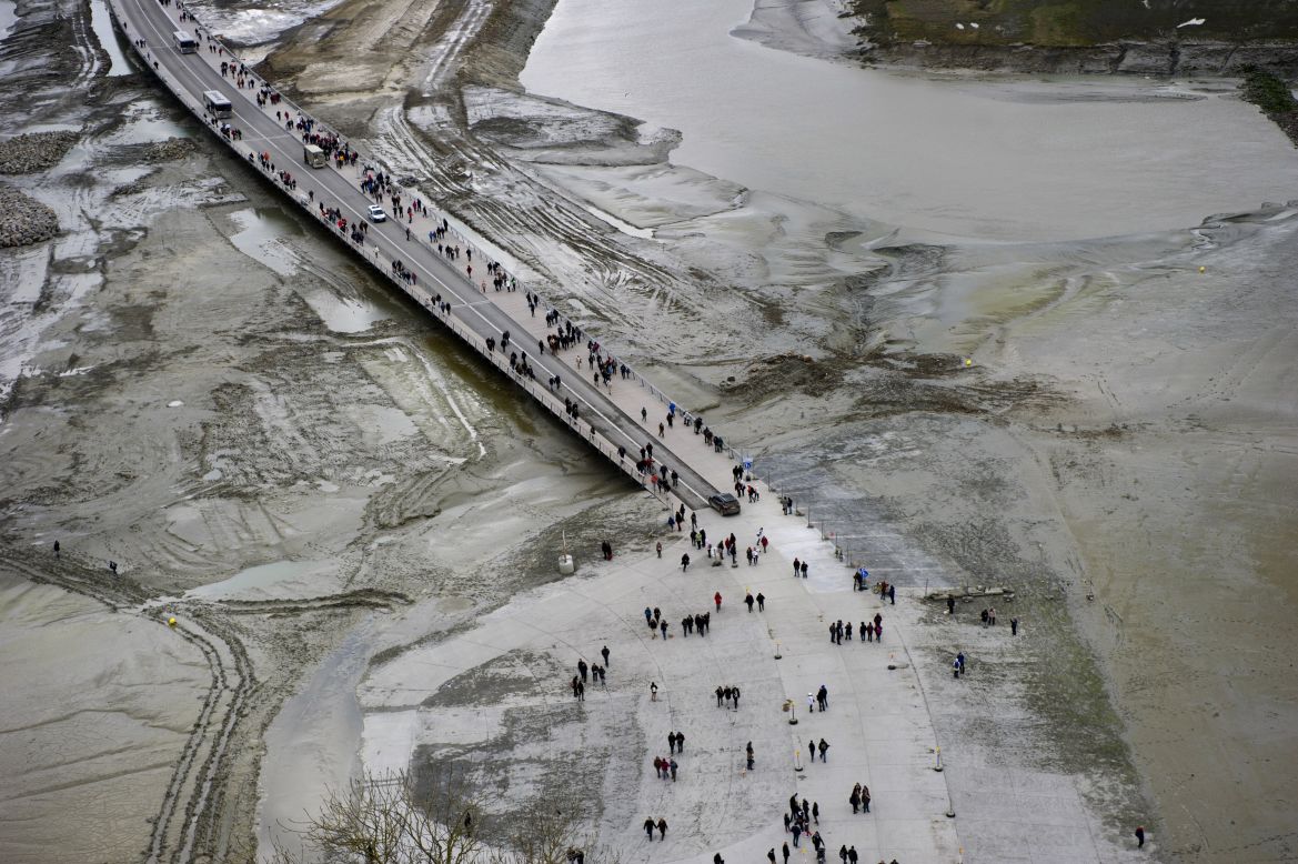 Around 3 million people visit each year. Here, some are seen walking to the site before the water rose.