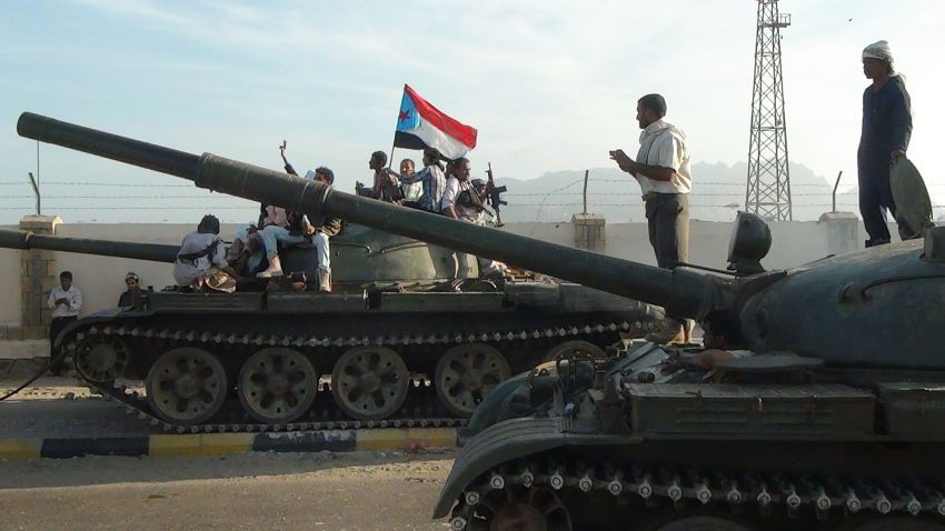 Armed Yemeni militiamen loyal to President Abedrabbo Mansour Hadi, also known as the Popular Resistance Committees, sit on tanks, one flying the separatist Southern Movement flag, outside the Yemeni special forces command base in the southern city of Aden on March 19, 2015.