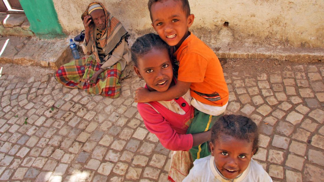 Harari children next to a blind man begging in the street while chewing the leaves of the narcotic plant khat, which comes from the region around Harar.
