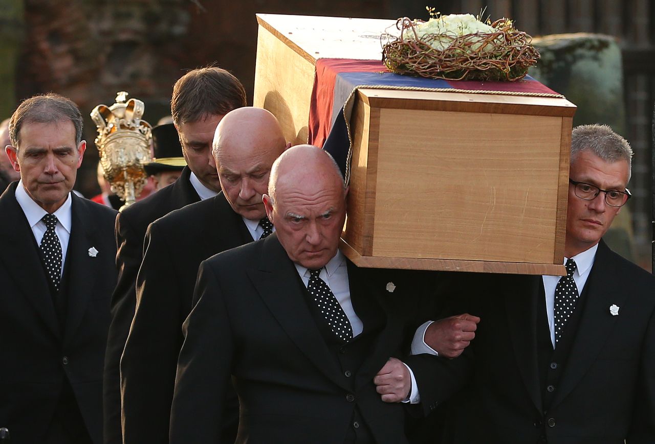 Pallbearers carry the coffin during the procession on March 22.