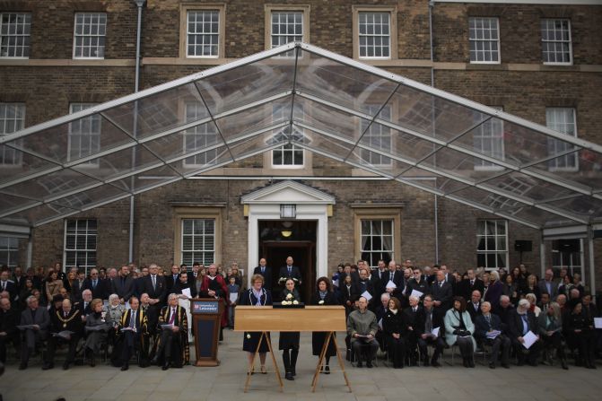 University of Leicester staff place white roses on the King's coffin on March 22.