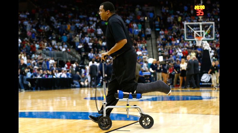 Georgia State head coach Ron Hunter wheels off the court after the first half of an NCAA Tournament game Saturday, March 21, in Jacksonville, Florida. Hunter tore his Achilles tendon earlier this month while celebrating his team's win in the Sun Belt Conference tournament. He nearly hurt himself again when <a href="index.php?page=&url=http%3A%2F%2Fbleacherreport.com%2Farticles%2F2402692-georgia-states-rj-hunter-hits-game-winning-3-coach-falls-out-of-chair" target="_blank" target="_blank">he fell off a rolling stool</a> during his team's upset victory over Baylor.