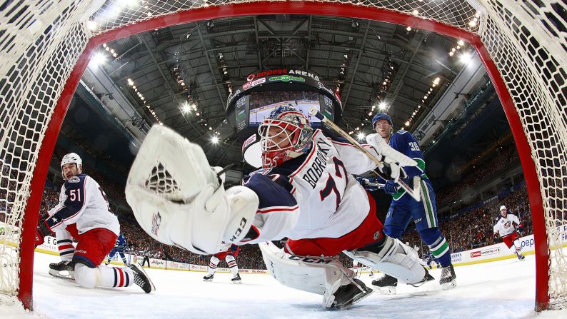 Columbus goaltender Sergei Bobrovsky reaches back for a save during an NHL game in Vancouver, British Columbia, on Thursday, March 19.