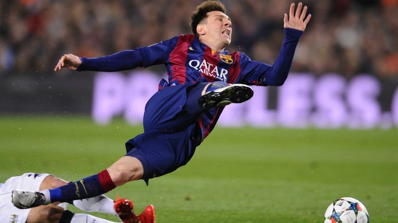 Barcelona's Lionel Messi is tripped during a Champions League game against Manchester City on Wednesday, March 18. Barcelona won the home match 2-1 and advanced to the quarterfinals of the European tournament, which it last won in 2011.