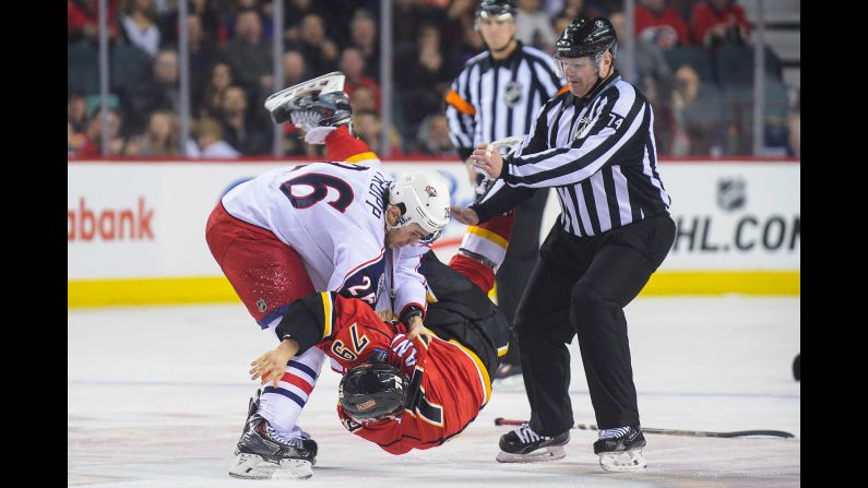 Columbus' Corey Tropp, left, fights Calgary's Michael Ferland during a NHL game played Saturday, March 21, in Calgary, Alberta.