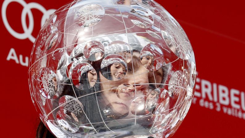 Austrian skier Anna Fenninger can be seen through the trophy that she won Sunday, March 22, for winning the World Cup overall title. Fenninger also won the overall title last season.