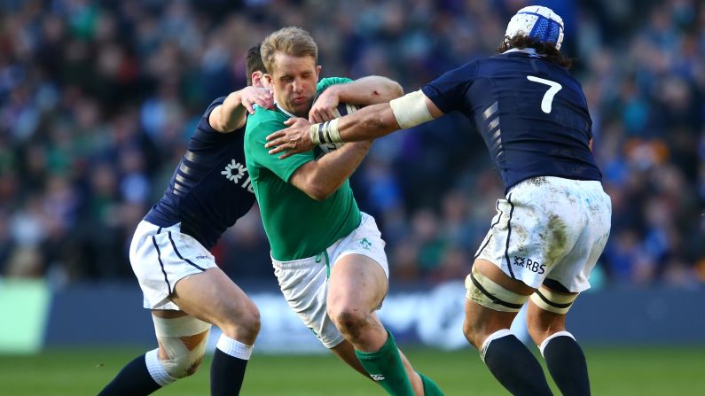 Ireland's Luke Fitzgerald, center, holds off two Scottish rugby players during a Six Nations match Saturday, March 21, in Edinburgh, Scotland. Ireland won the match 40-10 and retained its Six Nations title on points differential. Ireland, England and Wales all finished the competition with four wins and one loss, but Ireland had the final edge with a points differential of +62. England finished second at +57, while Wales finished third at +53.