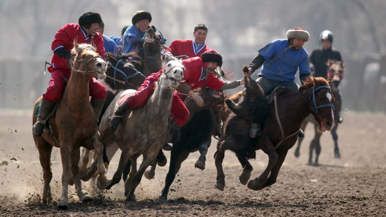 Horsemen in Bishkek, Kyrgyzstan, participate in the traditional sport of buzkashi on Tuesday, March 17. In buzkashi, players compete to place a goat carcass into a goal circle.