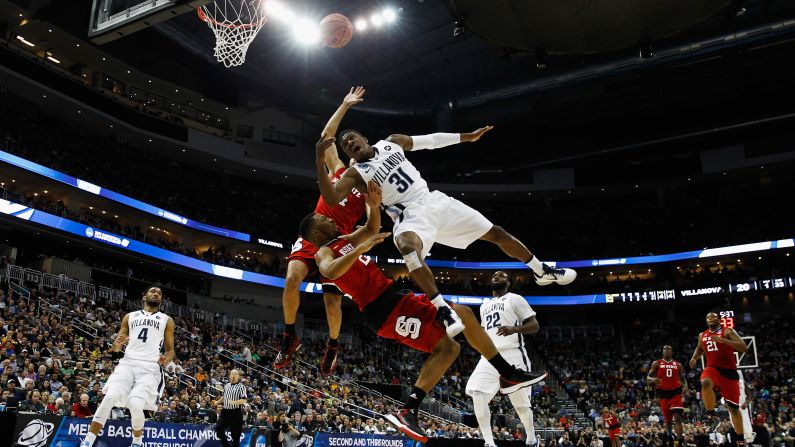 Villanova's Dylan Ennis is defended by two North Carolina State players during their NCAA Tournament game Saturday, March 21, in Pittsburgh. Villanova was the top-seeded team in its region, but it lost 71-68 in the round of 32. <a href="index.php?page=&url=http%3A%2F%2Fwww.cnn.com%2F2015%2F03%2F17%2Fsport%2Fgallery%2Fwhat-a-shot-sports-0317%2Findex.html" target="_blank">See 37 amazing sports photos from last week</a>