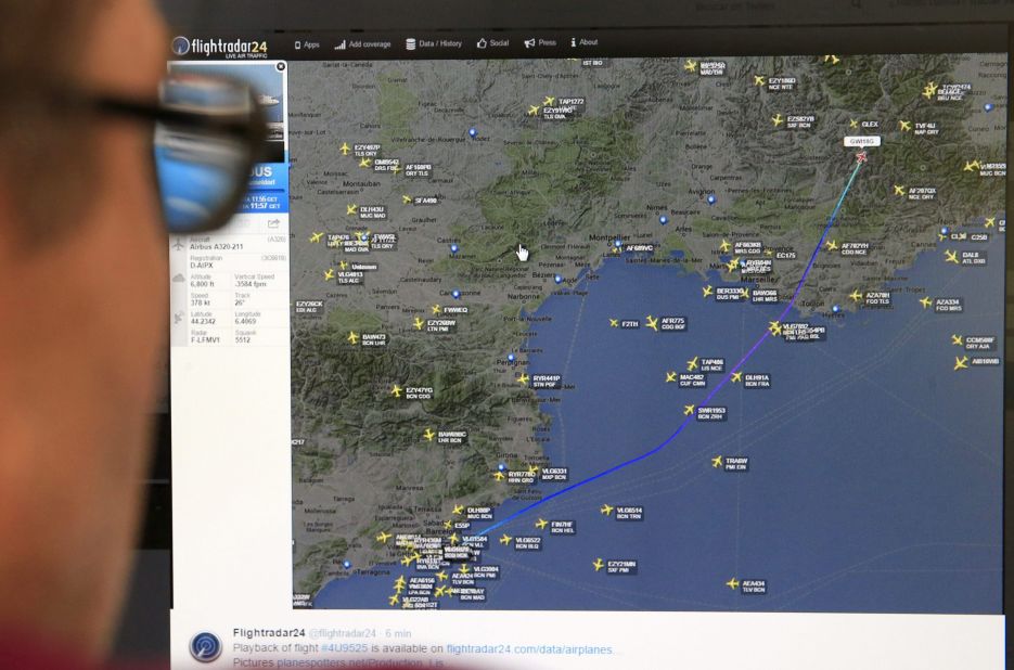 A man in Madrid looks at a monitor with a map, released from the Flightradar24 website, showing the point where the plane's radar signal went missing.