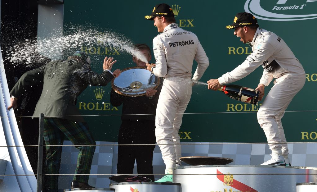 Hamilton (far right) sprays another three-time champion Sir Jackie Stewart with champagne after winning the opening race of the 2015 season in Australia.