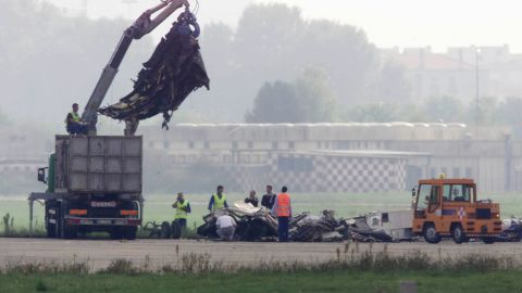 Workers remove wreckage of an MD-87 airliner that crashed at Linate Airport, near Milan, on October 8, 2001.