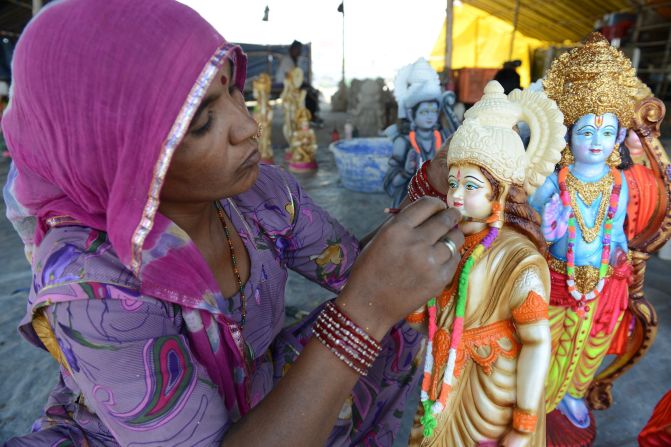 MARCH 24 - HYDERABAD, INDIA: An artist puts the final touches to statues of Hindu Gods Rama, his brother Lakshman, wife Sita and devotee Hanuman at a workshop ahead of the Rama Navami festival. Celebrations will be held on March 28, commemorating both the birth of Rama and his wedding to Sita.