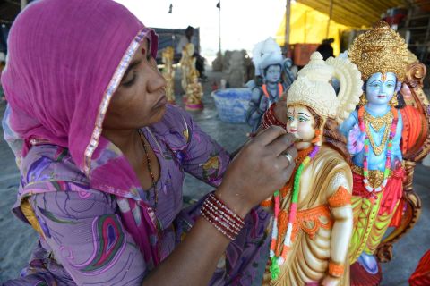 MARCH 24 - HYDERABAD, INDIA: An artist puts the final touches to statues of Hindu Gods Rama, his brother Lakshman, wife Sita and devotee Hanuman at a workshop ahead of the Rama Navami festival. Celebrations will be held on March 28, commemorating both the birth of Rama and his wedding to Sita.