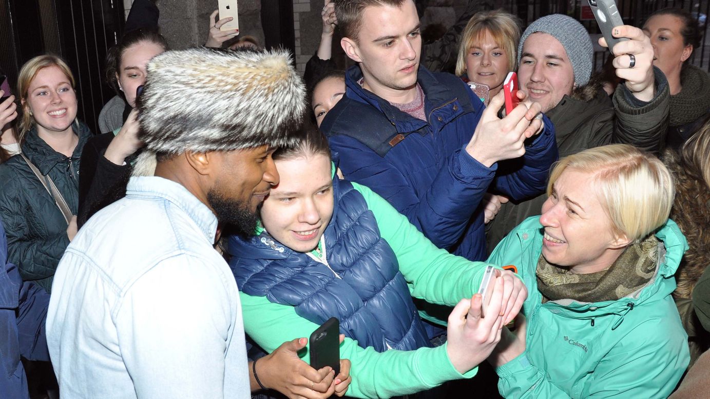 R&B artist Usher poses for fans who spotted him in Dublin, Ireland, on Thursday, March 19.