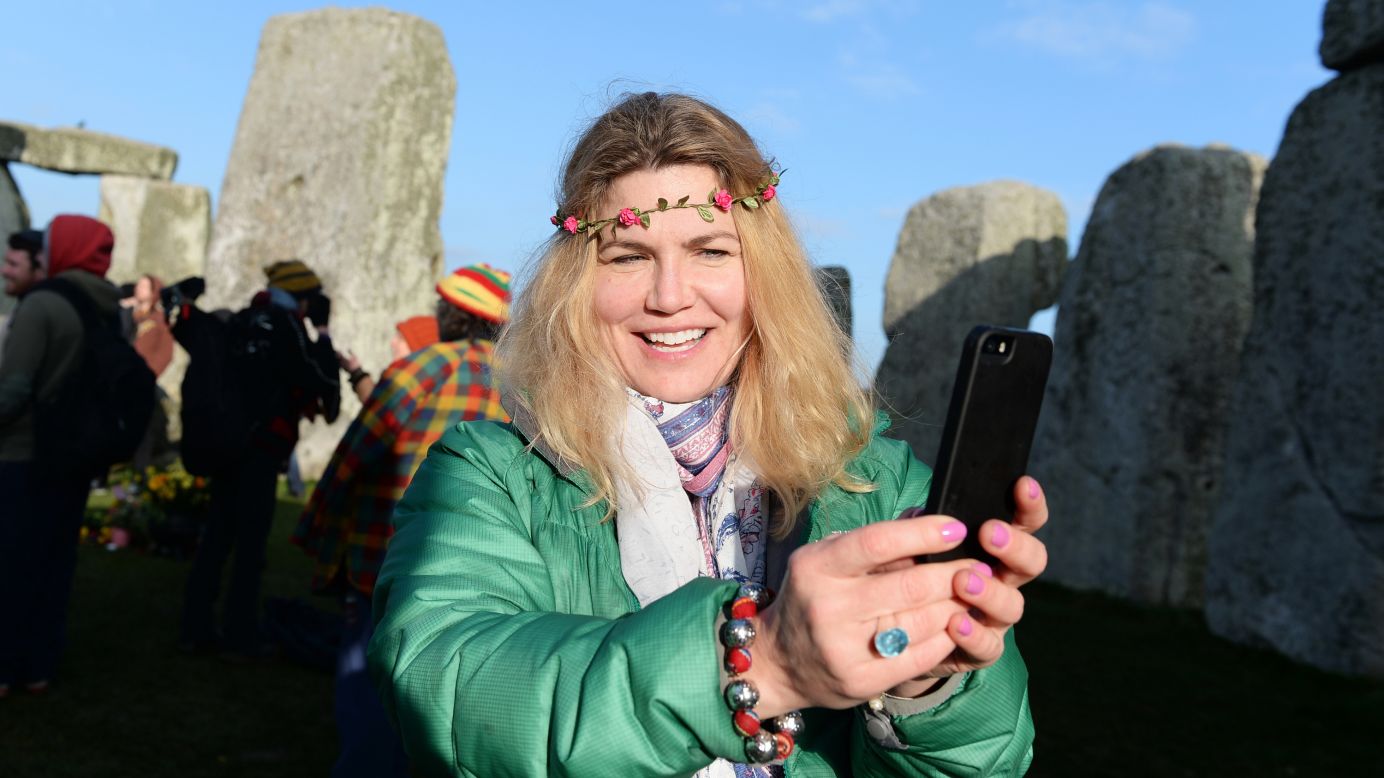 A woman takes a selfie during celebrations marking the spring equinox Saturday, March 21, at the Stonehenge monument in Wiltshire, England.