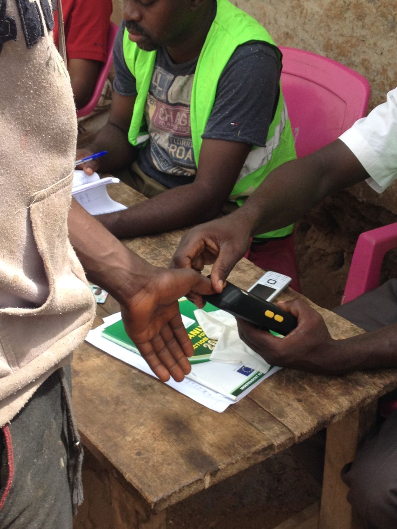 Election officials test voter card readers in preparation for the upcoming elections. "The introduction of the card readers is expected to reduce the possibility of electoral fraud and election rigging, and to further build the confidence of voters in the electoral process," explains YIAGA Program Manager, Cynthia Mbamalu.
