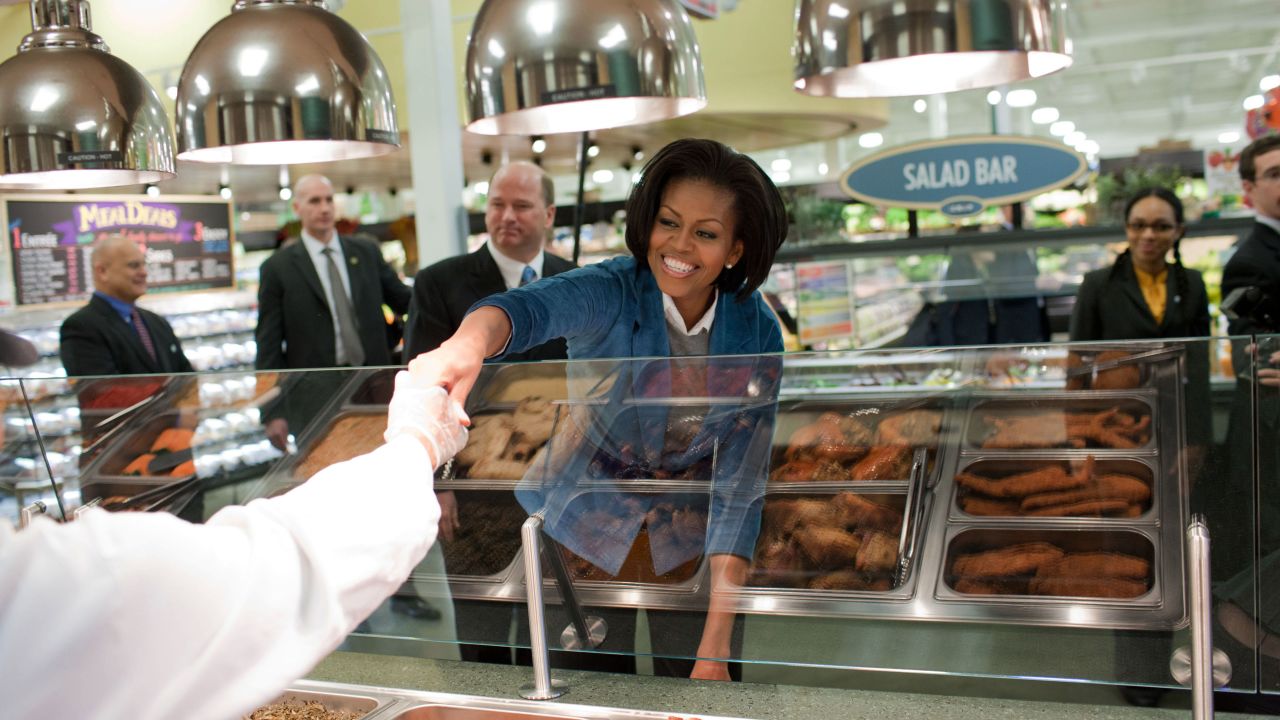 America still spends nearly $200 billion a year on obesity-related health care costs, and that figure will jump to nearly $350 billion a year by 2018, according to Let's Move! campaign. Michelle Obama visits the Fresh Grocer store in Philadelphia in 2010. 